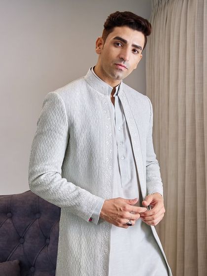 The open-front jacket is layered over a matching pastel kurta, offering a modern and comfortable option for a wedding guest who wants to look effortlessly stylish.