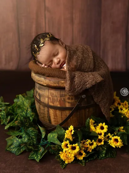 A touch of sunshine. Adding sunflowers to the rustic bucket setup brings a pop of color and a feeling of warmth and happiness to the portrait.