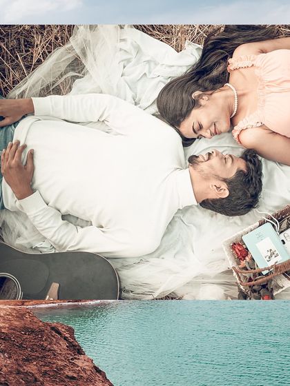 A sweet, intimate overhead shot of a couple lying on a picnic blanket, surrounded by their favorite things.