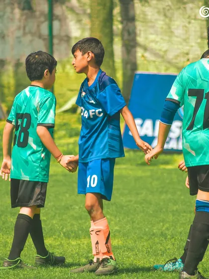 Players shake hands, demonstrating the sportsmanship we encourage in all our athletes.
