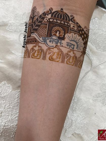 The initial outline of the 'Atmadipo Bhava' armband, showing the freehand lettering and drawing.