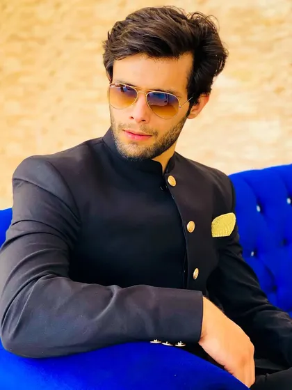 Adding sunglasses to the Jodhpuri suit gives it a cool, modern edge. Perfect for a daytime reception or pre-wedding shoot.
