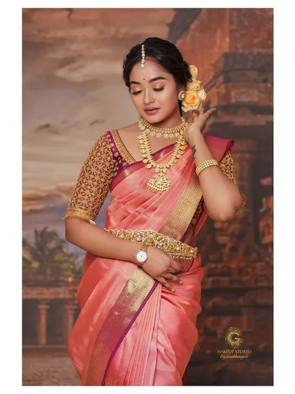 Another portrait of Sowmya John, highlighting the rich gold embroidery on the blouse and her traditional temple jewelry.