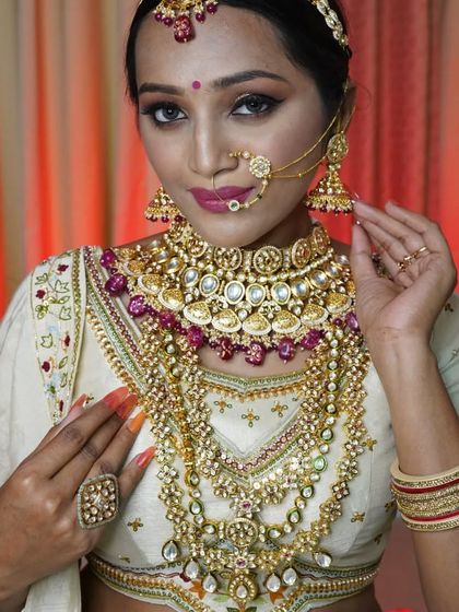 This bride is wearing one of our grandest rental sets, featuring intricate Polki and Kundan work with ruby-colored stones, perfect for a traditional red or maroon lehenga.