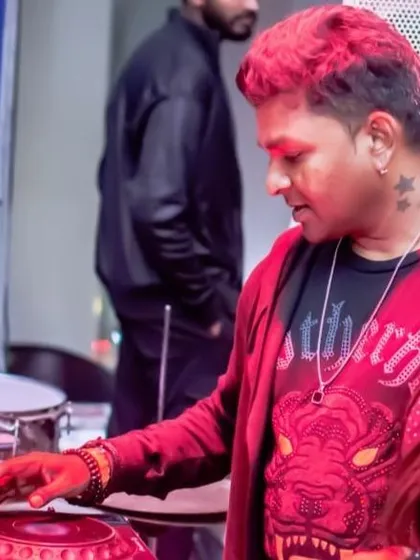 Sporting a different look with red hair for a special set. It's all about bringing a unique vibe to every performance, both in sound and style.