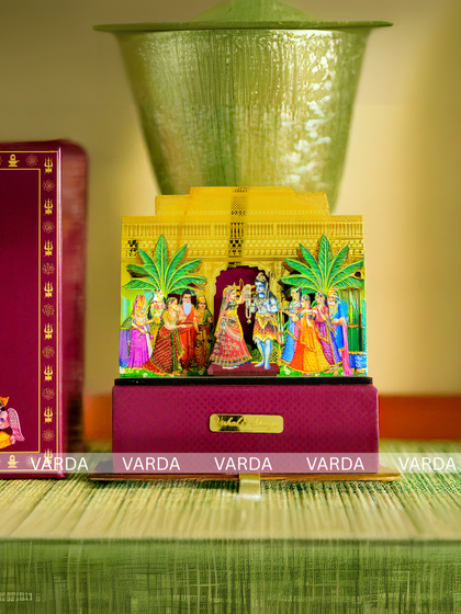 This boxed wedding invitation showcases a vibrant, multi-layered 3D artwork depicting a holy ceremony. The rich colors and intricate details make it a cherished memento for your guests.