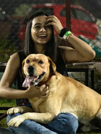 A happy guest enjoying a cuddle with her Labrador at the Halloween party. The best part of these events is seeing the joy they bring.