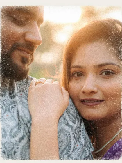 A soft, grainy portrait of a couple in a close embrace. The vintage film effect adds a warm and nostalgic feeling to this intimate moment.
