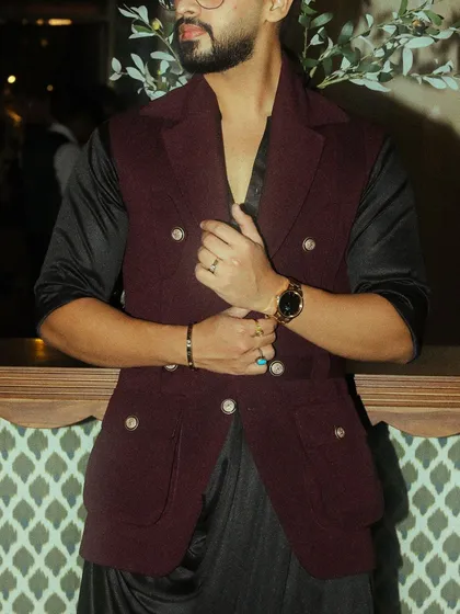 A detail shot of the burgundy waistcoat, highlighting the double-breasted design and custom buttons.