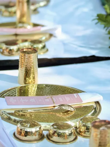 The elegant table setting for a modern Pangat. I use beautiful golden thalis and bowls, combining traditional serving styles with a touch of contemporary elegance.