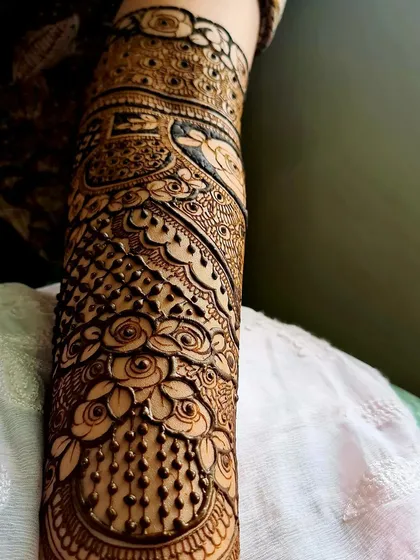 A close-up view of detailed rose motifs on the forearm. I focus on creating depth and dimension in my floral work, using shading and fine lines to make the patterns stand out.