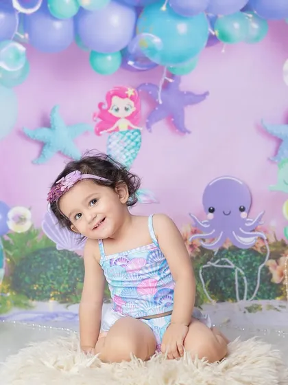 A sweet, shy smile from our mermaid. The purple and teal color palette is perfect for an under-the-sea adventure.
