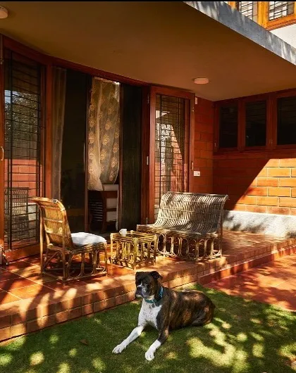 The covered veranda at the Reshma House in Utopia, Bangalore, exemplifies our focus on creating functional indoor-outdoor living spaces. This area provides a comfortable, shaded transition from the house to the garden, perfect for enjoying the climate.