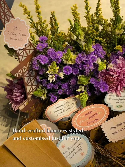 A Paris-themed hamper designed for a true romantic. It features a stunning floral arrangement, an Eiffel Tower cutout, and personalized tags with sweet messages, showing how I can bring any theme to life.