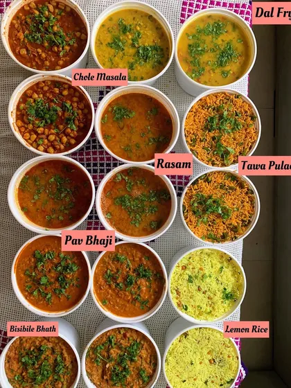 A beautiful spread of some of my popular dishes. This includes Chole Masala, Dal Fry, Rasam, Pav Bhaji, Tawa Pulao, and Lemon Rice, all bursting with homemade flavor.