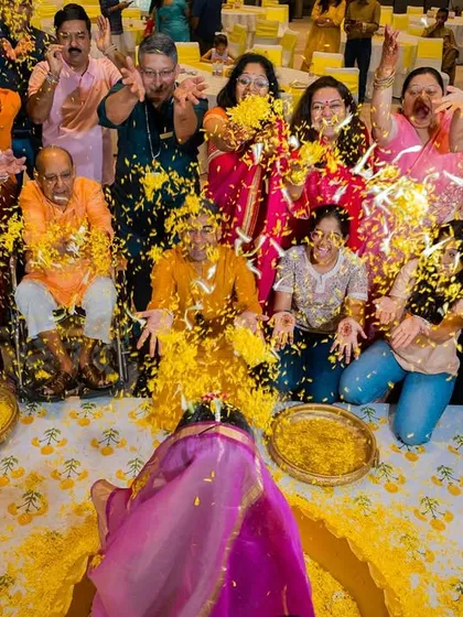 An explosion of joy and marigold petals as the bride is showered with love by her family and friends during her haldi.