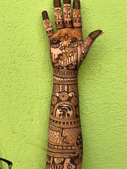 A close-up of one hand, showing the detailed work and clean lines of the design.