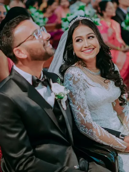 The couple shares a laugh during the ceremony, a beautiful, unscripted moment of joy.