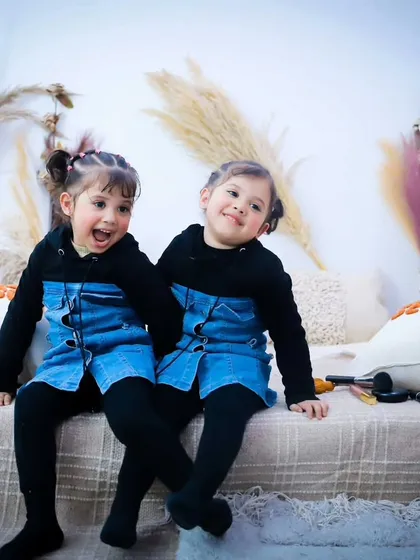 Full of expression! These twin sisters are having a blast during their photoshoot, and their personalities are shining through.