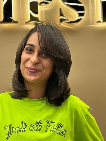 A happy client rocking her new short haircut. The style is fun, fresh, and full of personality.