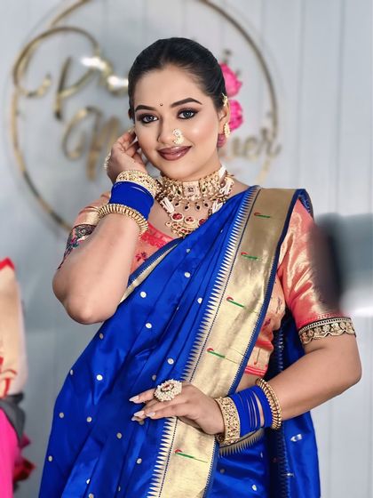 A close up of the 'Chandrika' look, highlighting the traditional nath, chandrakor bindi, and the beautiful smile of the model.