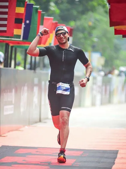 Crossing the finish line at an Ironman event. An unforgettable moment of triumph after months of relentless training.