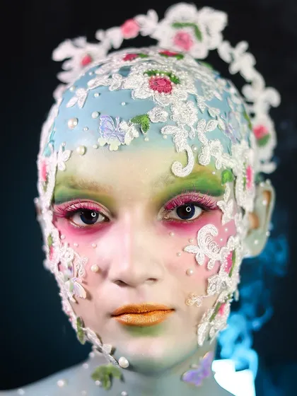 A delicate and intricate look using lace appliques and a bald cap to create a porcelain doll effect.
