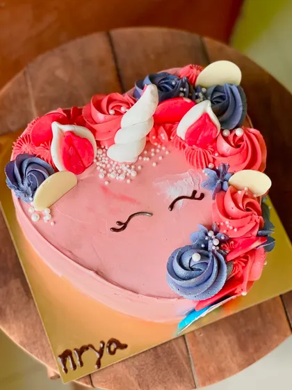 A whimsical heart-shaped unicorn cake. I use colorful buttercream swirls for the mane and a chocolate horn to bring this magical creature to life.