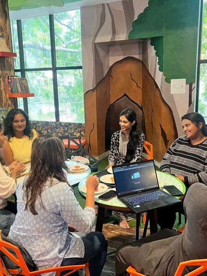 A parenting expert speaks to a group of engaged mothers during a "Mommy Moments" session, providing valuable insights and advice.