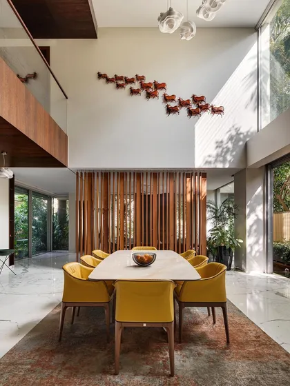 I design homes with spaces that breathe. This double-height dining area in the Kanasu residence connects vertically and opens horizontally to the outdoors, creating a sense of grandeur and seamless flow for family life.