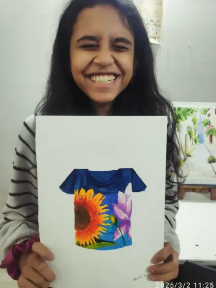A beaming smile from Bharti, a student from our CB2 batch. She is thrilled with her stunning T-shirt design featuring a large sunflower and lotus.