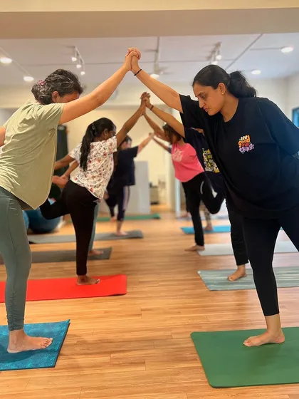 In our classes, we build strength and balance together. This partner-assisted tree pose not only improves stability but also fosters a sense of connection and support within our community.