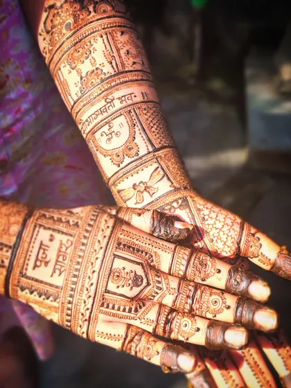 Personal touches make the mehendi special. Here, I've included the bride's name, 'Pooja', and a 'Saubhagya' mantra, which is a blessing for a happy married life.