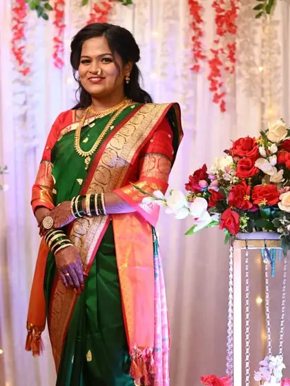 The bride looking radiant against the backdrop we created. The combination of red, white, and green in the decor and her saree looks stunning.