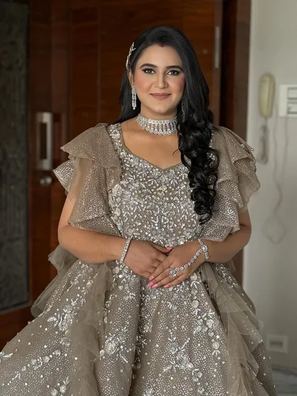 A full-length shot of the bride in her gorgeous reception gown. The makeup and hair are styled to create a cohesive and show-stopping look.