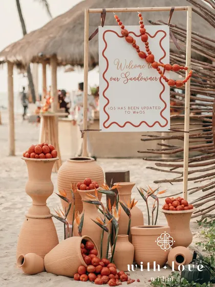 The welcome installation for the sundowner, with terracotta pots and a fun sign that reads "iOS has been updated to WeOS".