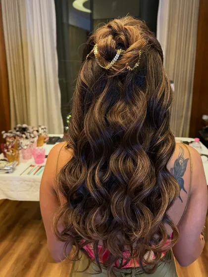 Another view of the half-up style, showing the voluminous curls and the bride's butterfly tattoo.