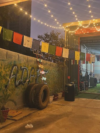The vibe at our gym in the evening, with the prayer flags and string lights. It's a place where you can focus on your training and find your peace.