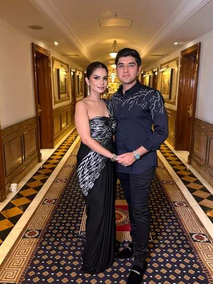 A beautiful couple shot showcasing her clean and modern party makeup. The sleek hair and sharp liner make for a powerful yet elegant statement.