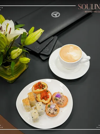 A beautifully plated coffee and snack selection at a corporate lounge. We believe even the smallest details contribute to a premium hospitality experience.