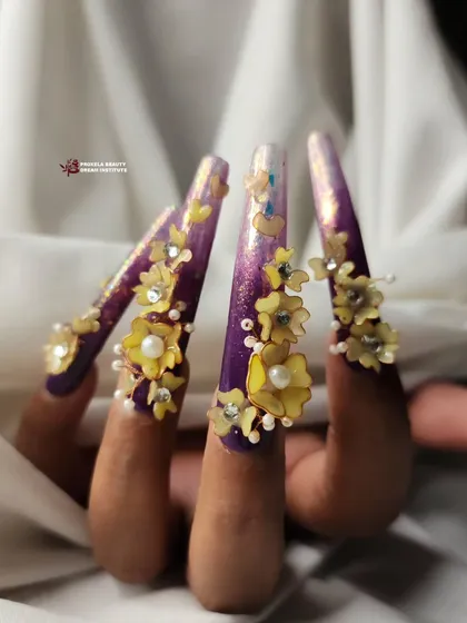 This angle captures the length and drama of the purple floral nails, showing how the 3D elements are placed along the extra-long extensions.