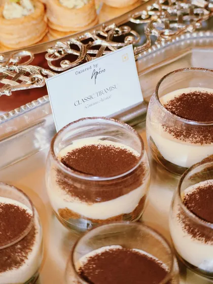 Classic Tiramisu served in individual glasses. This timeless Italian dessert, with its layers of coffee-soaked ladyfingers and creamy mascarpone, is always a crowd-pleaser.