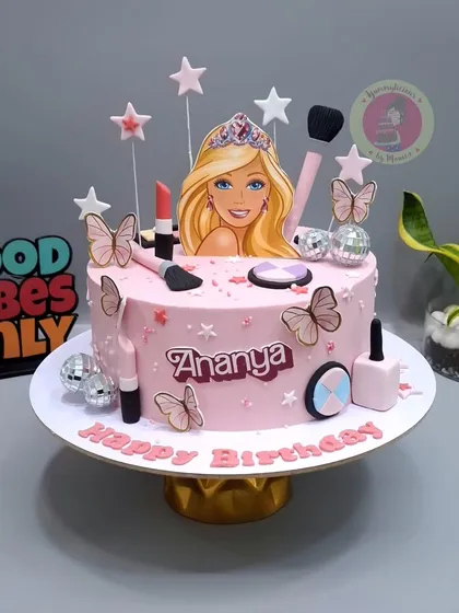 A fun and girly Barbie-themed cake with makeup elements and disco balls.