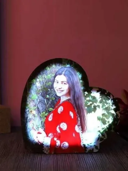 A simple and elegant heart-shaped photo lamp. The light from within illuminates your picture, creating a warm and personal piece of decor for a bedside table or desk.