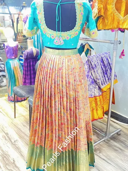 This vibrant lehenga set was created from a single floral saree. I used the body for the pleated skirt and designed a custom embroidered blouse to match.