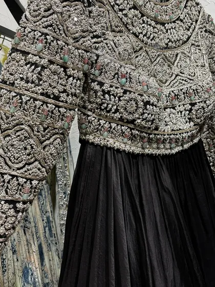 A stunning black Anarkali with a heavily embroidered jacket, spotted at Pernia's Pop-Up Shop. A perfect example of the kind of unique, high-fashion pieces you can find there.