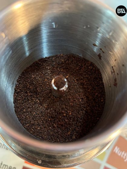 A look inside the Phin filter at the coarsely ground coffee. The grind size is important for achieving the right extraction time.