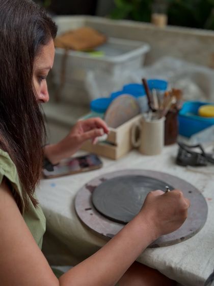 Carving designs into a clay plate. In my beginner workshops, you can personalize your piece to make it uniquely yours.