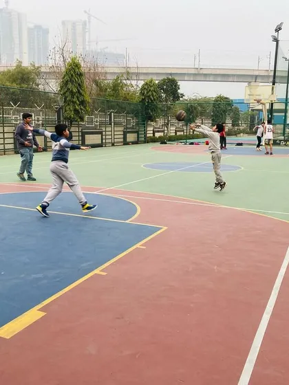 A player takes a long-distance shot during a practice game.