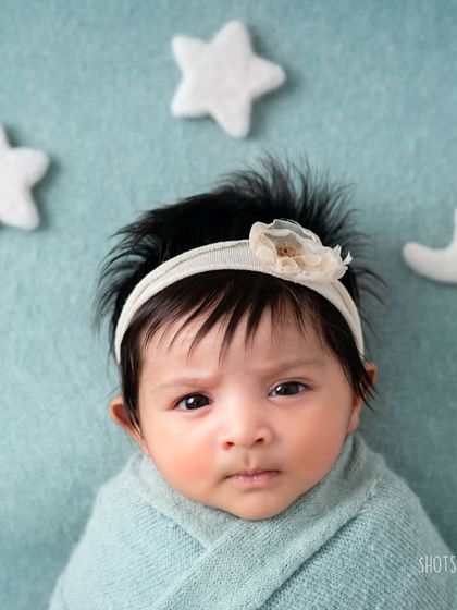 Wide-eyed and curious. While I love sleepy poses, capturing a newborn when they are awake and looking at the camera is a special treat.